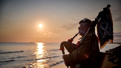 ARROMANCHES-LES-BAINS, FRANCE - JUNE 06: Lone Piper Yves Holbecq from the Somme Battlefield Pipe Band plays at sunrise to mark the 81st anniversary of the D-Day landings on Gold Beach on June 06, 2025 in Arromanches-les-Bains, Normandy, France. Today marks the 81st Anniversary of 'Operation Overlord', the Allied invasion of Normandy during World War II that led to the liberation of Western Europe and eventual defeat of Nazi Germany. (Photo by Kiran Ridley / Getty Images)