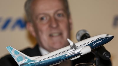 A Boeing 737 MAX miniature aircraft is displayed in front of the Malaysia Airlines chief executive Peter Bellew in Putrajaya, Malaysia. The airline on Wednesday announced a deal with the US plane maker for 50 737 MAX aircraft. Ahmad Yusni / EP