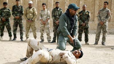 Shiite volunteers receive martial arts training at a military base in Najaf, southern Iraq (EPA/KHIDER ABBAS)