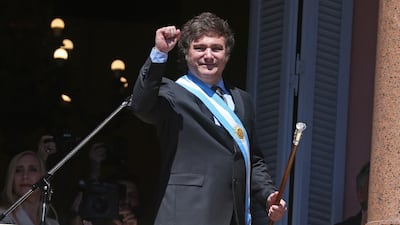 Argentina's new President Javier Milei gestures at the crowd from a balcony of the Casa Rosada government palace during his inauguration day in Buenos Aires. AFP