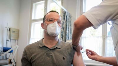 German Health Minister Jens Spahn gets an influenza vaccination at a doctor's surgery in Berlin. AFP