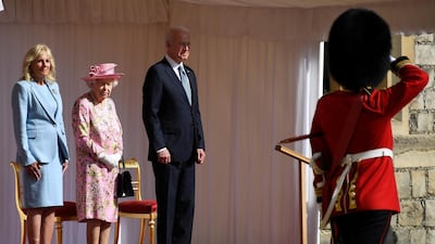 US President Joe Biden takes a salute from a Guard of Honour after arriving with First Lady Jill Biden to meet Britain's Queen Elizabeth II at Windsor Castle. Reuters