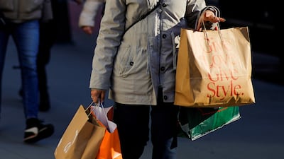A woman carries shopping bags during the holiday season in New York in a sign of robust consumer spending. Reuters