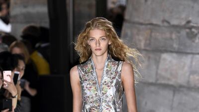 Metallic trousers and white sneakers make for an inspiring pairing. Bertrand Guay / AFP Photo