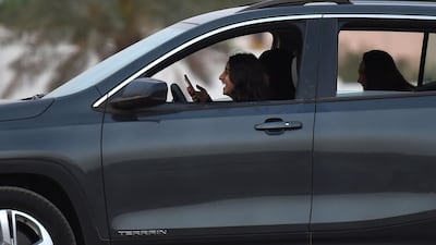 Saudi women take a test drive during an automotive exhibition for women in Riyadh on May 13, 2018. Saudi Arabia will allow women to drive on public roads from June 24, 2018. Fayez Nureldine / AFP