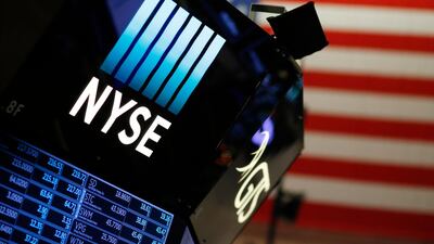 A logo for the New York Stock Exchange is displayed above a trading floor. AP / Mark Lennihan