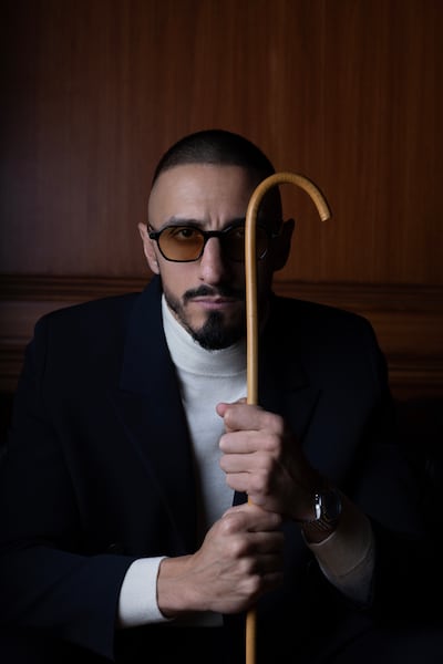 Jacket, Prada. Sweater, watch and sunglasses, Mohamed’s own. Chris Whiteoak / The National