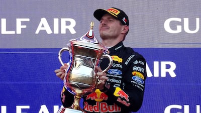 Red Bull's Max Verstappen celebrates with his trophy on the podium after winning the Bahrain Grand Prix. Reuters