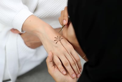 Khamissa at work, creating a design. Chris Whiteoak / The National