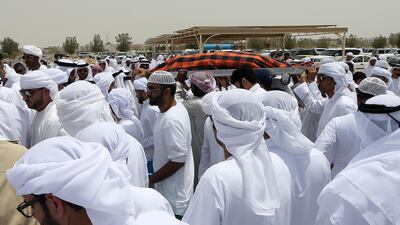 Friends and family carry the body of Khaled Qai, who died in a car accident en route to Salalah on Tuesday, for burial. Pawan Singh / The National