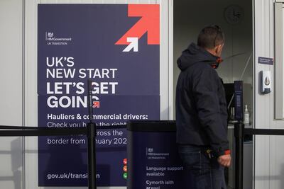 A pedestrian passes a portable government advice centre for lorry drivers and hauliers in Ipswich, UK. The government urged hauliers without the correct documentation to delay their journey to the EU to avoid delays. Bloomberg