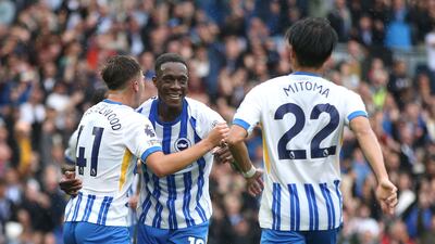 Danny Welbeck of Brighton & Hove Albion celebrates scoring his team's first goal - his 100th in all competitions - with teammates Jack Hinshelwood and Kaoru Mitoma. Getty Images