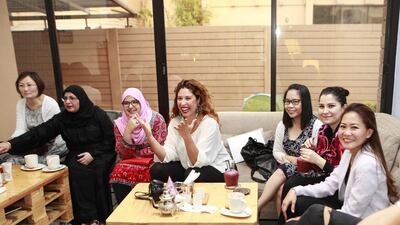 A meeting of the Gutsy Women Circle at The Third Place Cafe in Khalidiya. Abu Dhabi. Chérine Kurdi, pictured centre in the white blouse, is the founder of the group. Sarah Dea / The National