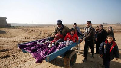 Displaced Iraqis, who fled ISIL, in the Intisar district of east Mosul yesterday. The US under Donald Trump will need to help answer many of region’s military and humanitarian problems. Khalid Al Mousily / Reuters