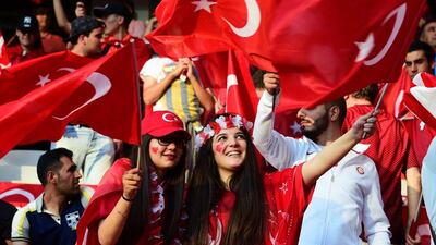 Turkey supporters wave the national flag ahead of the match between Spain and Turkey. Tobias Schwarz / AFP