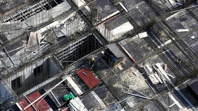 Above, a construction site for new apartments in Hanoi. An average high-end apartment now fetches $1,600 in the capital. Kham / Reuters