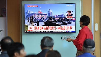 People watch a television news reporting a parade marking the 70th anniversary of the foundation of North Korea held in Pyongyang. AFP
