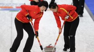 Jinli Lui, left, and Yan Zhou of the Chinese women's curling team at a practice session at the Vancouver 2010 Olympics.