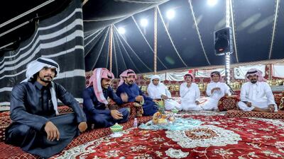 Abu Dhabi, United Arab Emirates, December 10, 2019. Men of the Dawasir tribe from Saudi Arabia relax after a victory of a one-year-old beauty camel at the Al Dhafra Festival in Abu Dhabi, UAE. Victor Besa / The National Section: NA Reporter: Anna Zacharias