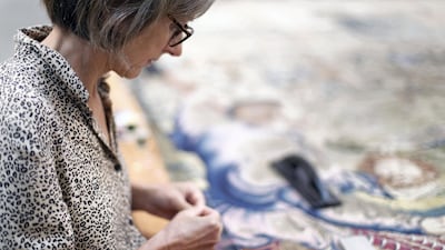 Montaine Bongrand, art restorer, working on a 17th-century tapestry at the Louvre Abu Dhabi. Reem Mohammed / The National