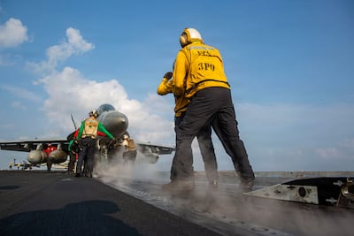 A US sailor prepares an EA-18G Growler to launch from the aircraft carrier USS Abraham Lincoln in support of Operation Epic Fury. AFP
