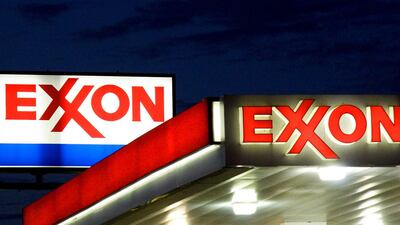 Exxon signs at a petrol station in Manassas, Virginia. Exxon is cutting 1,90 jobs in the US as part of a broader plan to shed 14,000 staff over the next two years, AFP