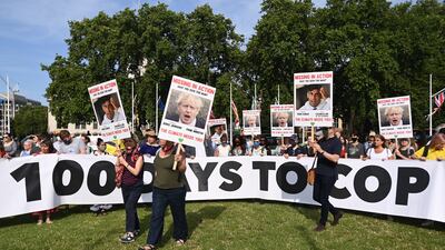 Climate change campaigners protest outside Parliament in London. EPA