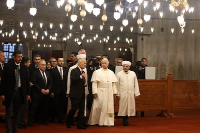 Asgin Musa Tunca guides Pope Leo XIV around the Sultan Ahmed Mosque, also known as The Blue Mosque, in Istanbul. Getty Images