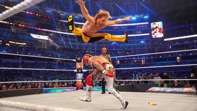 Logan Paul jumps over Rey Mysterio.