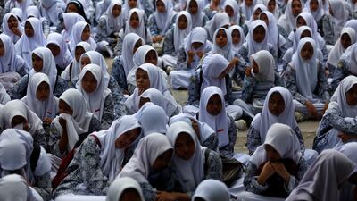 Students gather at an open area and act as survivors during a tsunami and earthquake drill at Aceh Junior High School 1 in Banda Aceh, Indonesia, 07 August 2024. According to the principal of Junior High School 1 Banda Aceh, Ms Risma, the school initiated to stage a disaster mitigation exercise with their students as part disaster awareness education. Most of Indonesia's archipelago is known as a disaster prone area as it lies in the Ring of Fire, the most active Tectonic plate in the world. EPA / HOTLI SIMANJUNTAK