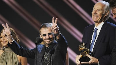 Musician Ringo Starr, centre, and Beatles producer Sir George Martin accept the best compilation soundtrack album award for "Love" during the 50th annual Grammy awards in 1998. Kevork Djansezian / AP