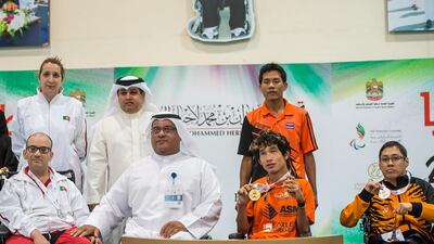 Watcharaphon Vongsa of Thailand, centre, flashes gold from the BC2 discipline at the Fazza International Boccia Competition with Abalio Valente of Portugal, left, winning silver and Lee Chee Hoong, right, of Malaysia winning bronze. Photo Courtesy / HHC Media