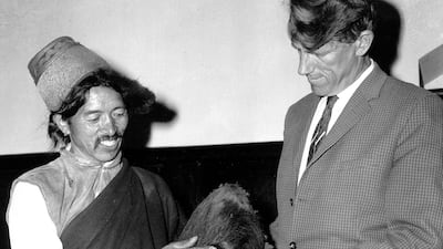 Edmund Hillary, one of the first two people to scale Mount Everest, and Khunjo Chumbi, a Nepali village elder, hold what was then thought to be the scalp of yeti, in Calcutta, India, on December 9, 1960. AP Photo