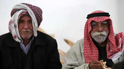 Yazidi men eating at the health centre in Altun Kopri where those released by ISIL have been receiving medical attention. Safin Hamid/AFP Photo