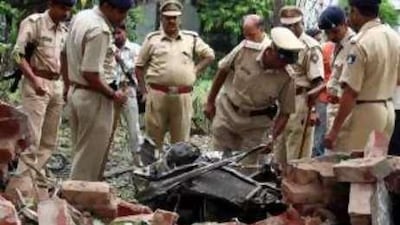 Security personnel search for evidence near a bomb blast site in Ahmedabad.