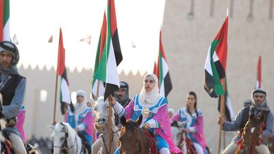 Performers hold the UAE flag high in the Union Parade. Mohamed Al Hammadi / Presidential Court
