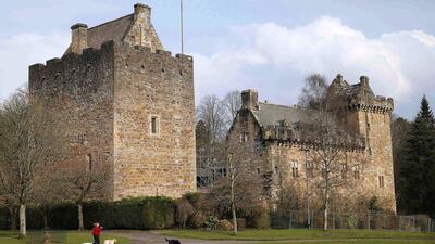 A woman walks her dogs outside Dean Castle in Kilmarnock. Suzanne Plunkett / Reuters