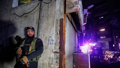 Syrian security forces secure the area around a building that, according to state media, was hit by rockets on Friday. AP