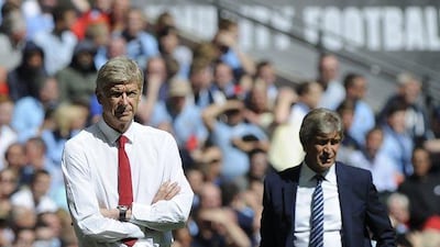 Arsenal manager Arsene Wenger, left, and Manchester City Manuel Pellegrini give instructions to their players during the FA Community Shield at Wembley stadium in London, Britain, on August 10, 2014. EPA/FACUNDO ARRIZABALAGA