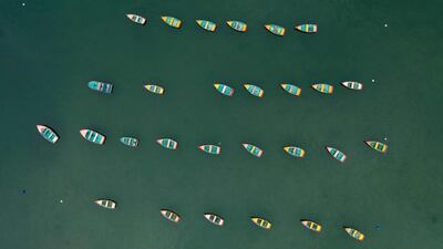 Row boats moored near a jetty.