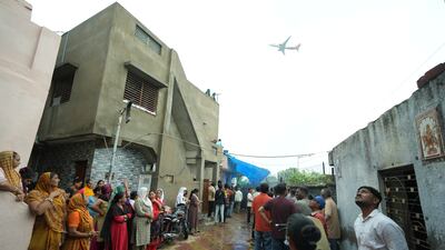 People wait for the funeral procession for Rajendra Patankar, a victim of the Air India plane crash in Ahmedabad. AP