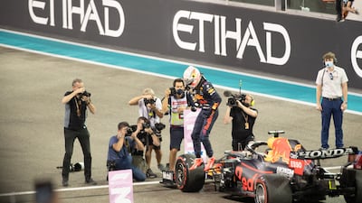Race winner and 2021 F1 World Drivers Champion Max Verstappen of Netherlands and Red Bull Racing celebrates on the podium during the F1 Grand Prix of Abu Dhabi at Yas Marina Circuit. Victor Besa/The National.