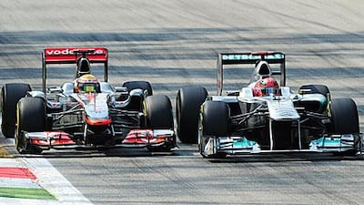 Every driver is allowed to move once but Michael Schumacher, right, weaved more than that to keep Lewis Hamilton at bay.
