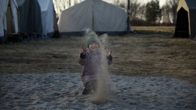 Ukrainian refugee Masha, 6, plays at the border crossing in Budomierz, Poland. Reuters