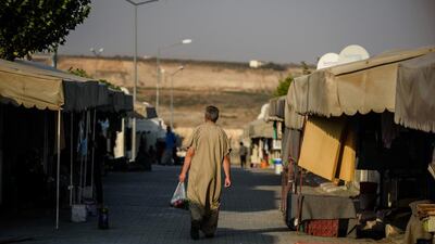 A Syrian man walks at a refugee camp in the Kilis district of Gaziantep, southeastern Turkey. Economists have long debated whether giving humanitarian aid in cash or in kind is better at encouraging long-term development Ozan Kose / AFP Photo