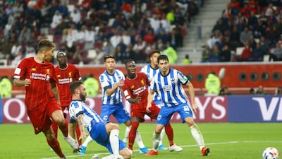 Roberto Firmino, left, scores the winner for Liverpool in the 91st minute. AP