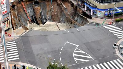 A huge sinkhole is seen at an intersection near Hakata station in Fukuoka, Japan. Kyodo via Reuters