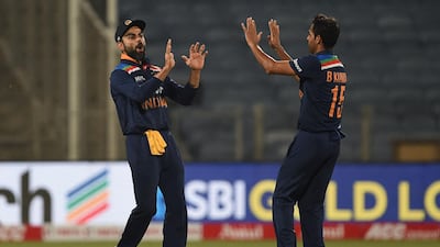 India's captain Virat Kohli celebrates with Bhuvneshwar Kumar the dismissal of England's Adil Rashid in the first ODI in Pune on Tuesday. AFP