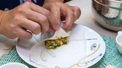 The brik is stuffed in spring roll pastry, then rolled and sealed with water. Victor Besa / The National