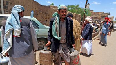 Yemenis fill gas cylinders amid a plummeting rial and increasing shortages in the capital Sanaa. Mohammed Huwais / AFP